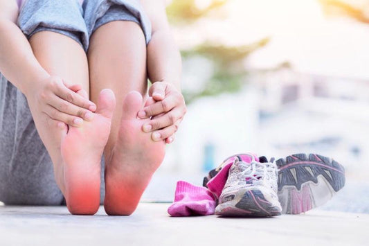 A Woman rubbing her sore inflamed feet