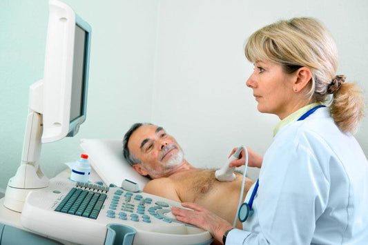Mature male getting chest ultrasound at doctor's office.